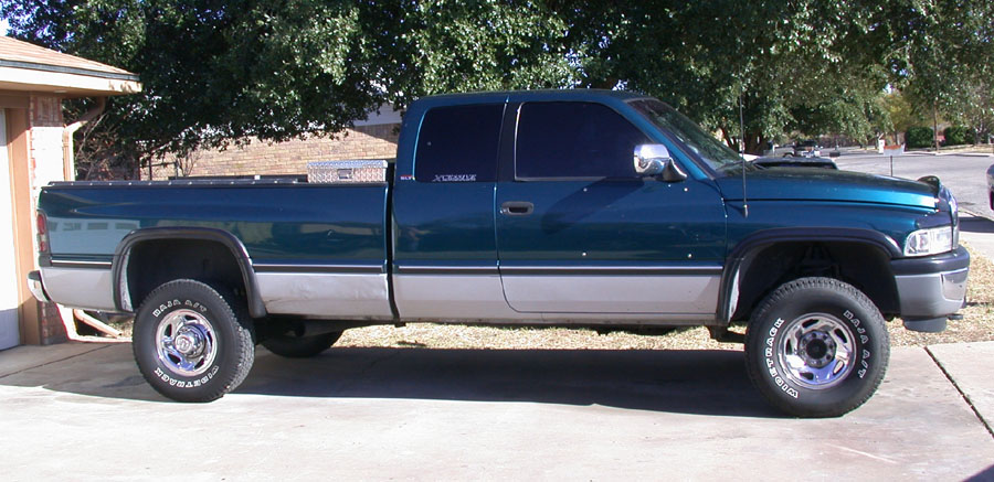 Side view of a 1997 Dodge 2500 pickup truck parked in a driveway