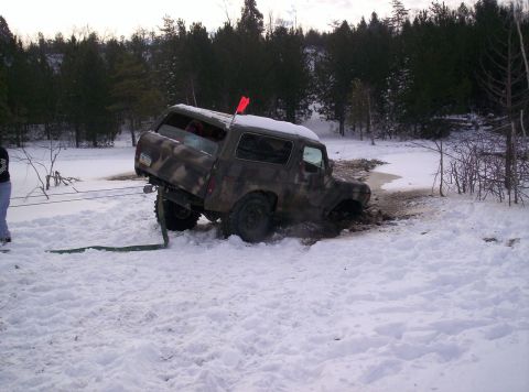 1996 Ford Bronco - Off-road vehicle attempts to navigate a snowy and muddy terrain.