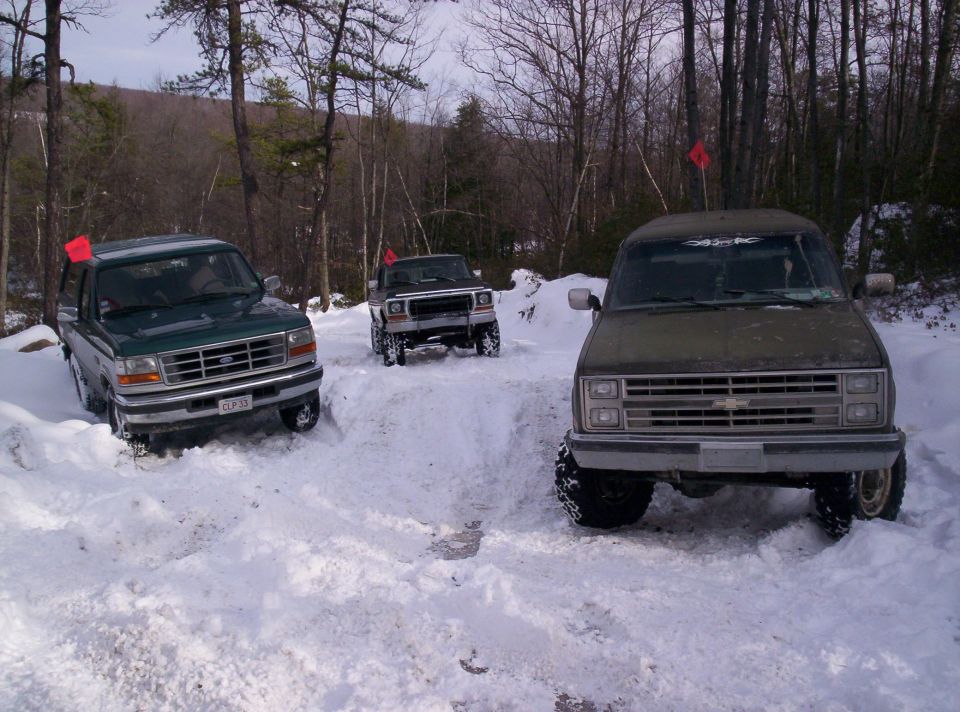 Green 1995 Ford Bronco in snow, front view