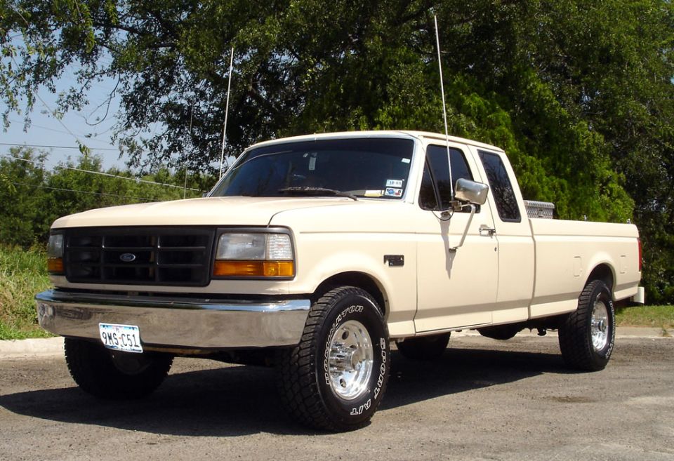 Cream-colored Ford F-250 pickup truck, four doors, parked outside