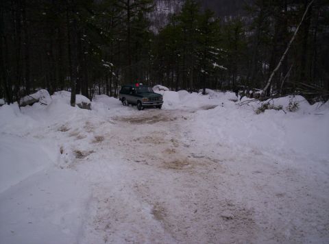1996 Ford Bronco - Ford Bronco navigating a snowy path through a wooded area.