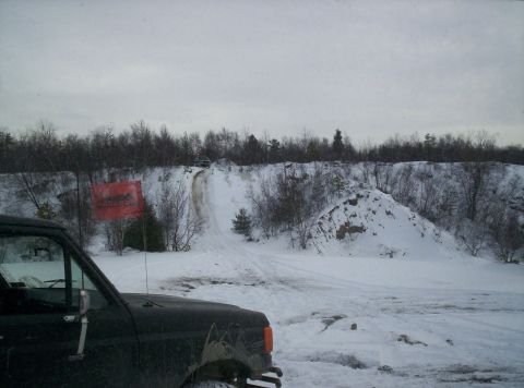 1996 Ford Bronco - A dark Ford Bronco is parked in the snow with a red flag planted nearby.