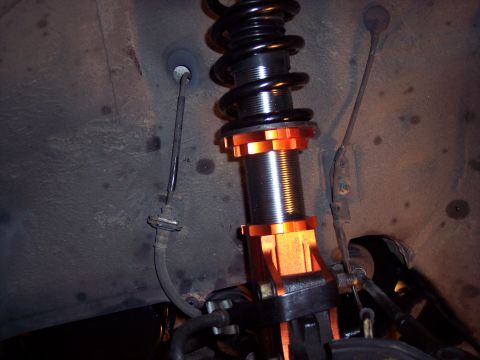1995 Ford Probe - Close-up of an adjustable coilover suspension component, likely for aftermarket modification.