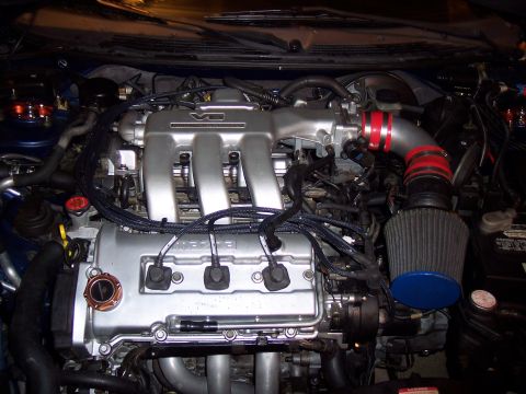 1995 Ford Probe - Engine bay with V6 engine, aftermarket intake, and visible 'MAZDA' branding.