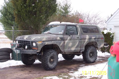 1979 Ford Bronco - Camouflaged 1978 Ford Bronco with winch, parked outside in winter conditions.