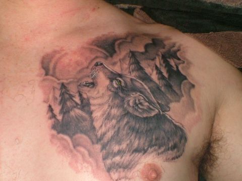 1989 Ford Bronco - Chest tattoo features a wolf howling amidst a forest scene under a full moon.