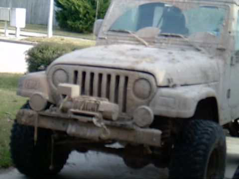 2004 Jeep Wrangler - This Jeep Wrangler appears to have recently been off-roading, covered in mud from bumper to windshield.
