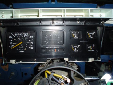 1984 Ford Bronco - Close-up of a vehicle's dashboard gauges, including the speedometer, fuel, oil, temperature, and charge indicators.
