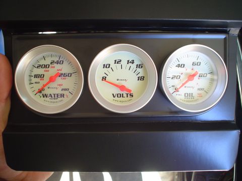 1984 Ford Bronco - A set of three aftermarket gauges are visible in the vehicle's interior.