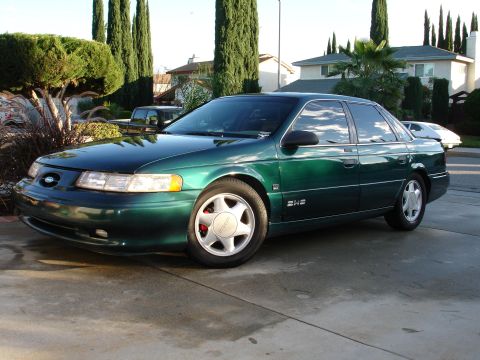 1993 Ford Taurus - This 1993 Ford Taurus sedan is shown in a three-quarter front view, highlighting its distinctive body style.