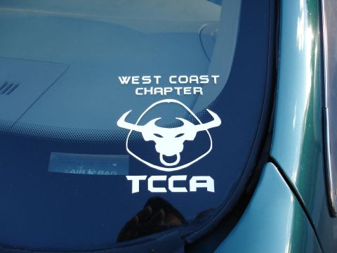 1993 Ford Taurus - A sticker with 'WEST COAST CHAPTER' and a bull logo is applied to a car's windshield.