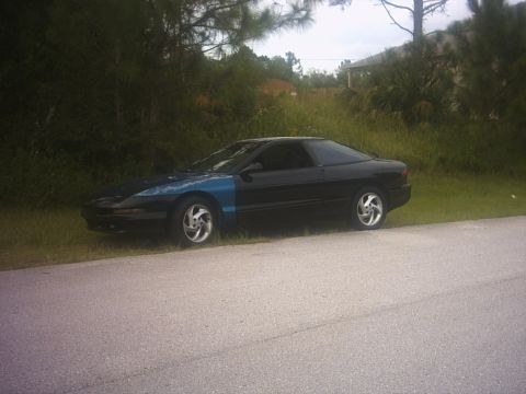 1994 Ford Probe - Side view of a 1994 Ford Probe, notable for its mismatched blue front fender.