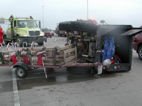 1992 Ford Bronco - Trailer decorated for Christmas is parked next to a utility truck and other vehicles.
