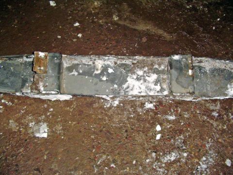 1994 Ford Bronco - Close-up of a corroded metal frame component, possibly from a vehicle's undercarriage.