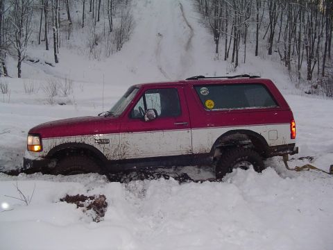 1994 Ford Bronco - This 1994 Ford Bronco is deeply stuck in the snow, with its front right wheel almost completely covered.
