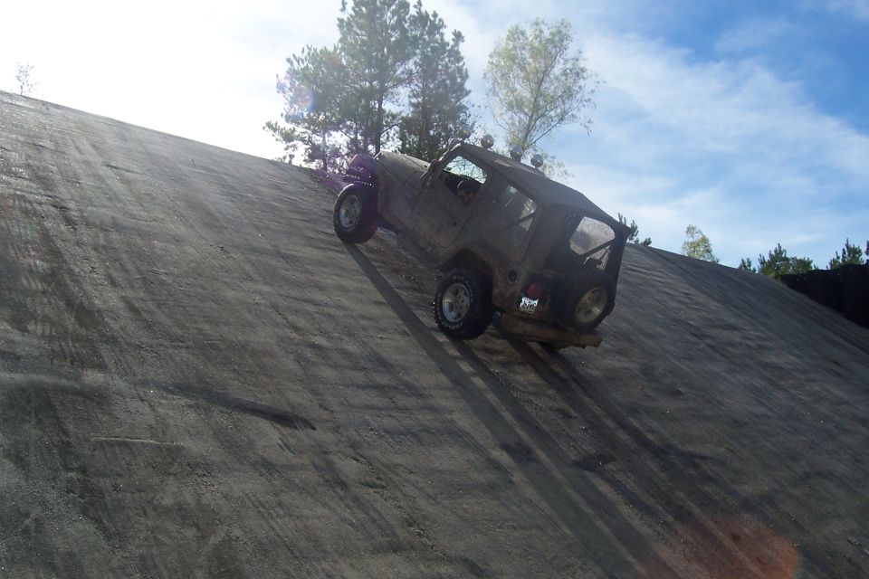 Jeep Wrangler climbing a steep dirt hill