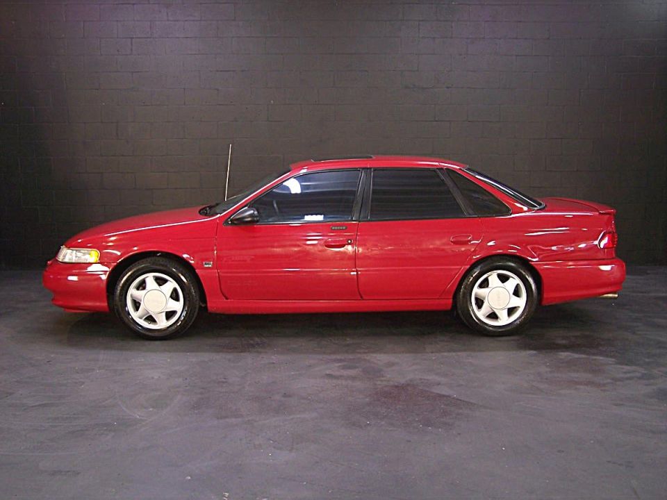 Red 1995 Ford Taurus sedan, side view