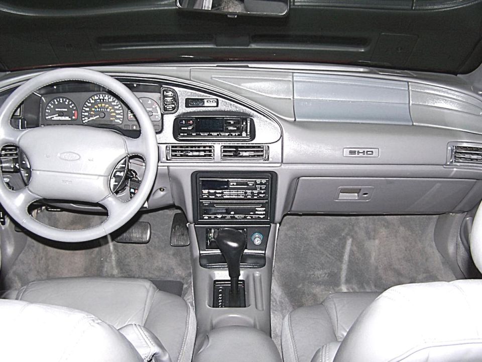 Gray dashboard and steering wheel of a Ford Taurus SHO with automatic shifter and gray leather interior