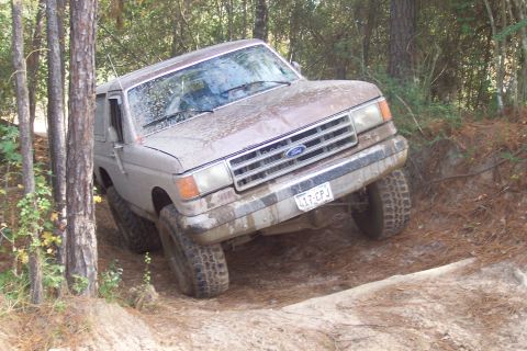 1987 Ford Bronco - This 1987 Ford Bronco is navigating a challenging off-road trail.
