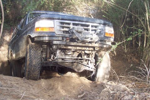 1987 Ford Bronco - This black Ford Bronco appears to be from the 1992-1996 generation, seen here navigating rough terrain.