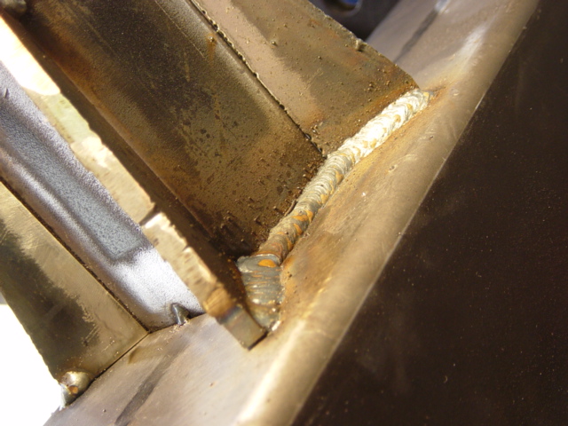 Lots of spatter and not the best penetration, but the remainder of this piece is overengineered.  I'm still learning to work with thicker sections with this welder -- it's small, so heavier sections require *very* good joint preparation and technique.  This bumper is a less critical item -- it's designed for a 25,000lb pull even with mediocre welds factored in, and hence will be *far* stronger than the original hitch receiver it replaces either way.  However, it gives me a chance to practice before doing the cab crossmember, which is much more critical.