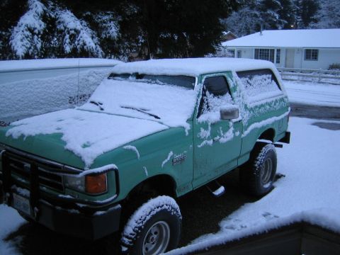 1990 Ford Bronco - 1990 Ford Bronco parked in the snow during winter.