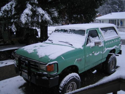 1990 Ford Bronco - 1990 Ford Bronco parked outside during a snowfall.