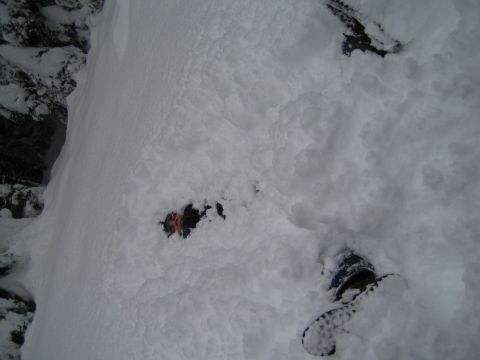 1990 Ford Bronco - A person is stuck in deep snow, with only their boots and part of their body visible.