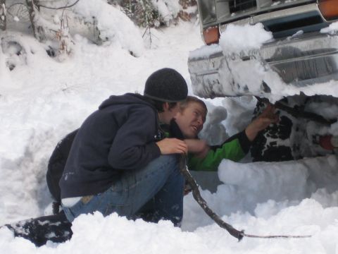 1990 Ford Bronco - Two men attempt to free a 1990 Ford Bronco stuck deep in the snow.