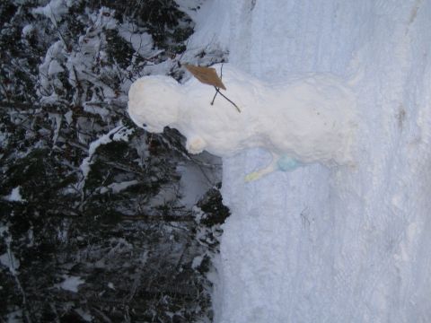 1990 Ford Bronco - A snowman made of snow sits in a winter forest scene.