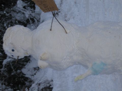 1990 Ford Bronco - A snowman stands in the snow with a sign hanging from it that reads "Show me your tits!".