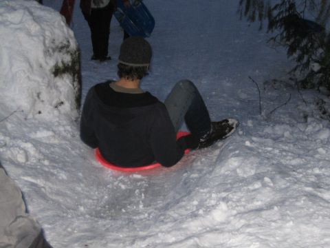 1990 Ford Bronco - Winter fun with friends, sledding down a snow-covered hill.