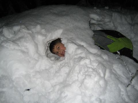 1990 Ford Bronco - A child is buried in a snowdrift, with only their head visible.