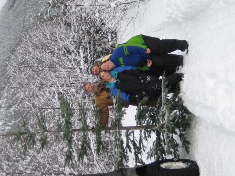 1990 Ford Bronco - A group of people are gathered together in a snow-covered wooded area.