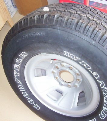 1995 Ford Bronco - A single tire and wheel assembly is shown, with visible text on the tire sidewall.