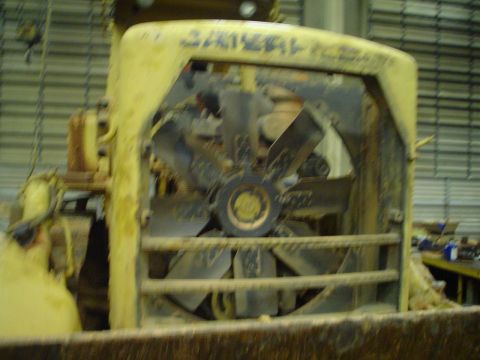 1966 International School Bus - Close-up of a yellow engine fan with black blades, likely from a heavy-duty vehicle or industrial equipment.