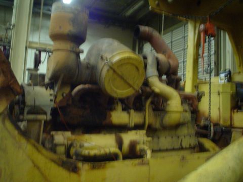 1966 International School Bus - Close-up view of a large, industrial engine with prominent yellow and red piping.