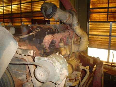 1966 International School Bus - Engine components including turbocharger, exhaust, and alternator are visible in this close-up shot.