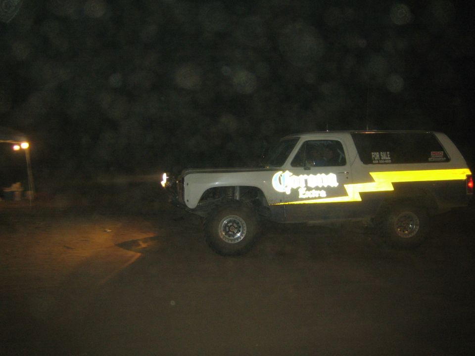 Two-tone Dodge Ramcharger SUV with Corona Extra graphics at night