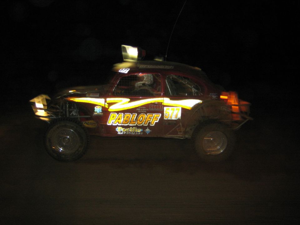 Beetle-bodied off-road racer lettered PABLOFF number 517 at night