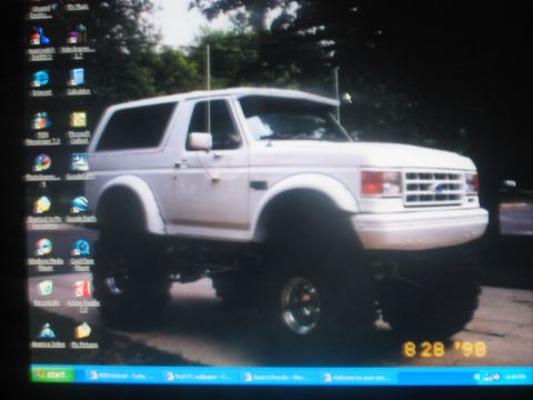 1991 Ford Bronco - This lifted SUV is shown from a 3/4 front angle, with a date stamp of 8 28 '98 visible.