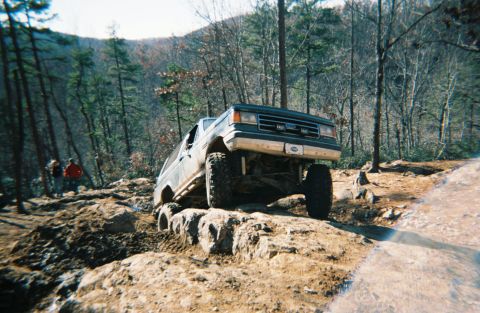 1990 Ford Bronco - This 1990 Ford Bronco is tackling a challenging off-road course on a rocky incline.