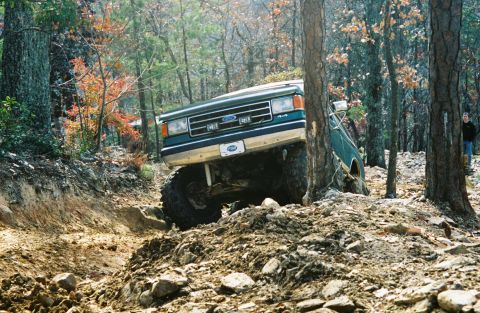 1990 Ford Bronco - A 1990 Ford Bronco navigates a challenging, rocky off-road course.