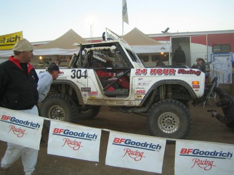 White Bronco race truck 304 in BFGoodrich pit at dawn