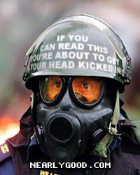 1989 Ford Bronco - A person in a gas mask and helmet with a warning message is pictured up close.