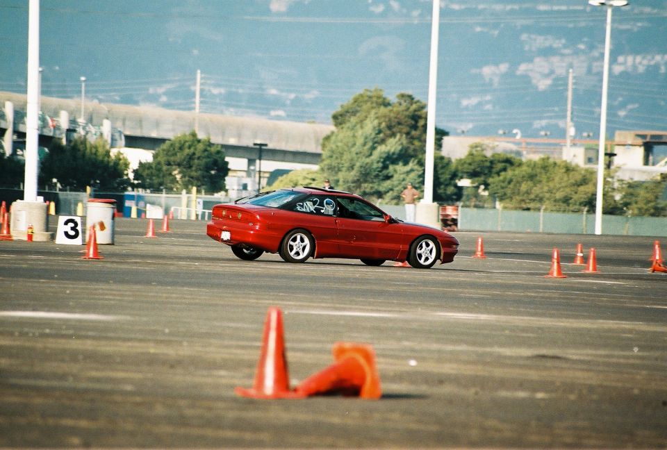 Red 1997 Ford Probe on race track, 3q-front view
