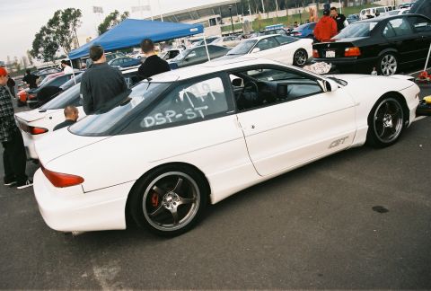 1997 Ford Probe - A white 1997 Ford Probe GT is parked at an auto-x event, with 'DSP-ST' written on its rear window.