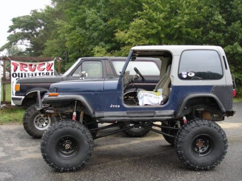1995 Jeep YJ - Truck Outfitter's owner, Jake, has a bronco on 40's. What's he say? "Sure you can use my shop"