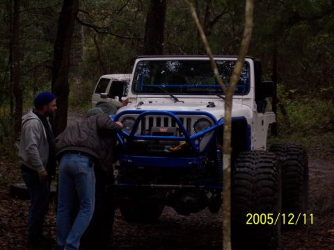 1989 Ford Bronco - Modified Jeep Wrangler in woods, with another vehicle in background. Date stamp shows 2005/12/11.