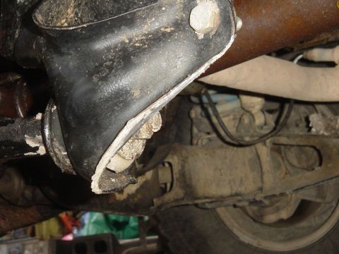 1989 Ford Bronco - Underside view of a vehicle's suspension system, highlighting a damaged component.